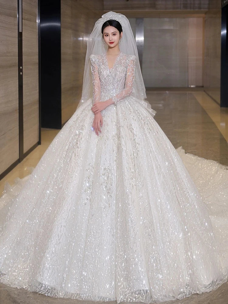 Elegant Beaded Bridal Gown With Long Sheer Veil