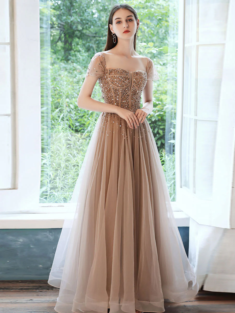 Dusty Beige Sequin Bodice Tulle Gown With Sheer Sleeves And Flowing Skirt Dusty Beige Sequin Bodice Tulle Gown With Sheer Sleeves And Flowing Skirt