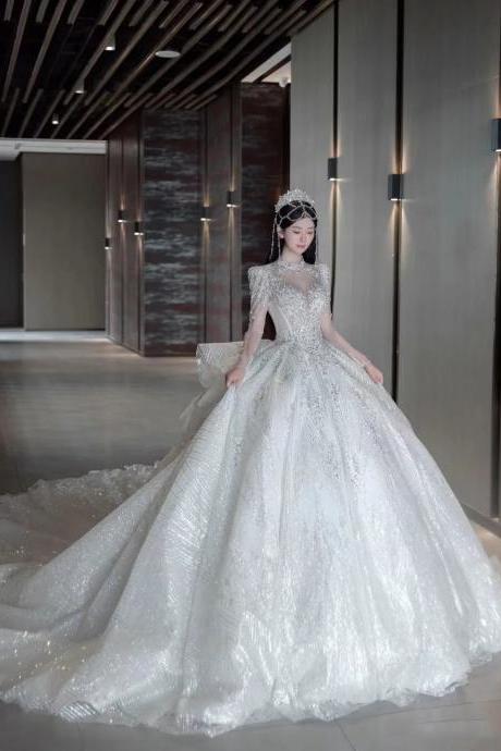 Luxurious Beaded Long-sleeve Bridal Ball Gown With Train