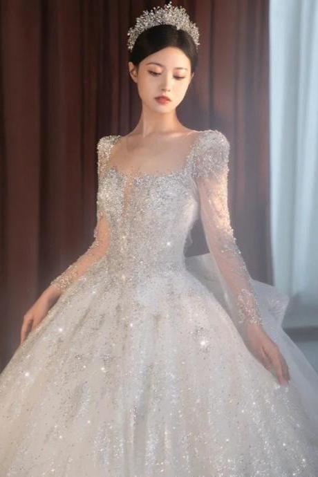 Elegant Long-sleeve Beaded Bridal Ball Gown With Tiara