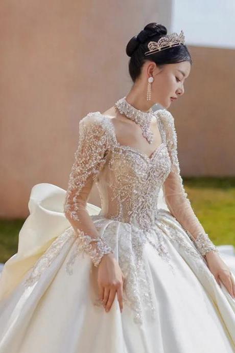 Elegant Long Sleeve Beaded Ball Gown Wedding Dress