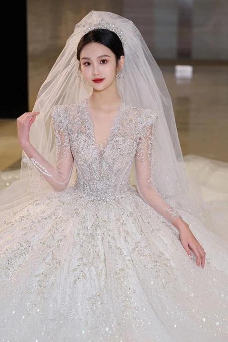 Elegant Beaded Bridal Gown With Long Sheer Veil