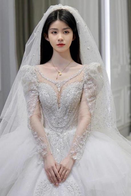 Elegant Long-sleeve Beaded Bridal Gown With Veil
